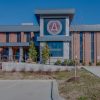 A two-story brick building with a sign that says 'Associated General Contractors of America' on the front.
