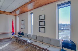 A bright waiting area with comfortable chairs and a view of the outdoors.