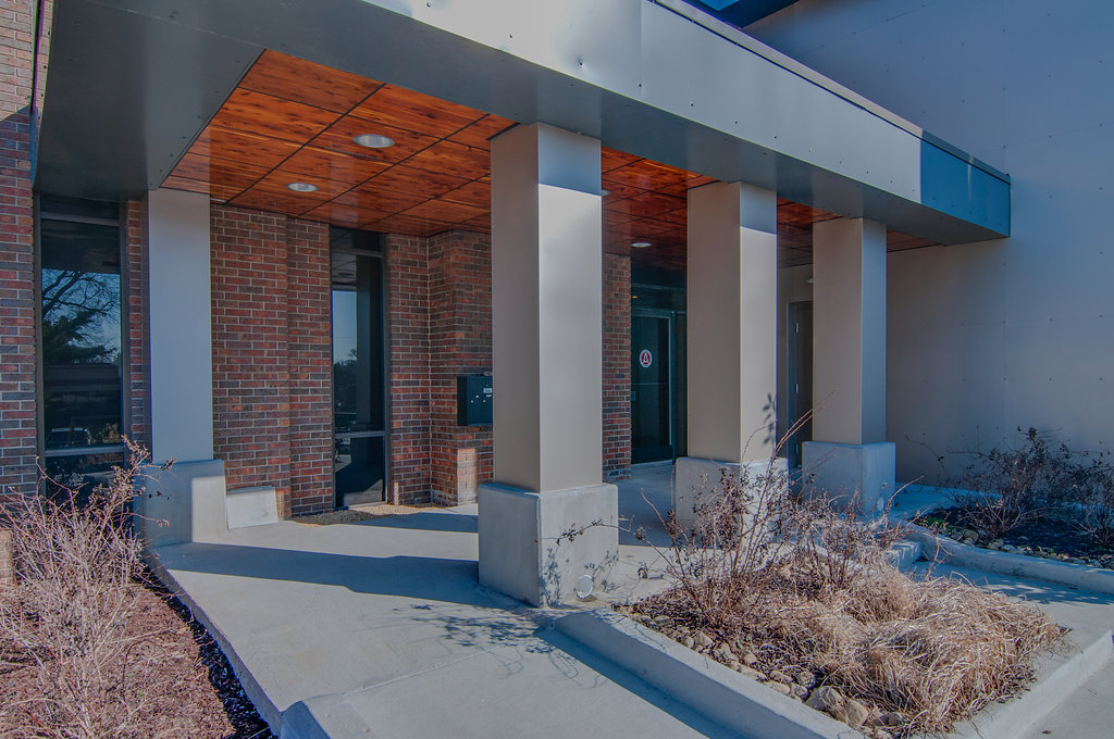 A building with big, square pillars and a wood ceiling.