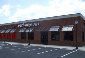 Verizon Wireless store located in a parking lot, showcasing the brand's signage and surrounding vehicles.