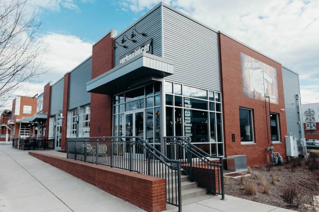 Modern commercial building designed by Nashville architects at Design Build Partners featuring brick exterior, metal siding, and large storefront windows in Tennessee.
